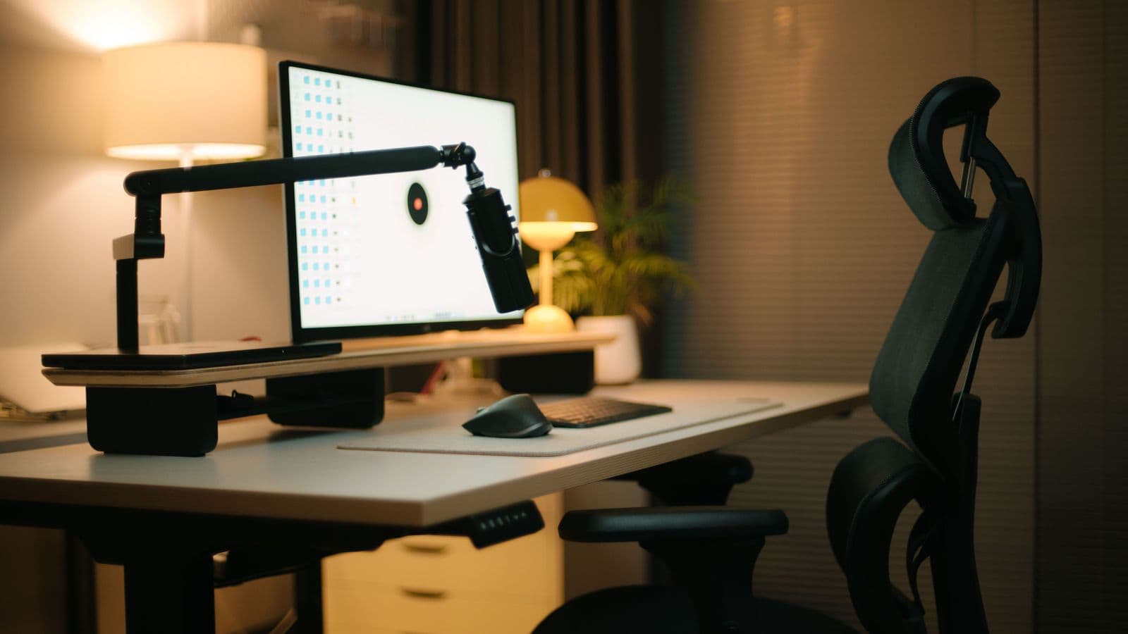 Modern desk with computer, chair, and ergonomic workspace accessories